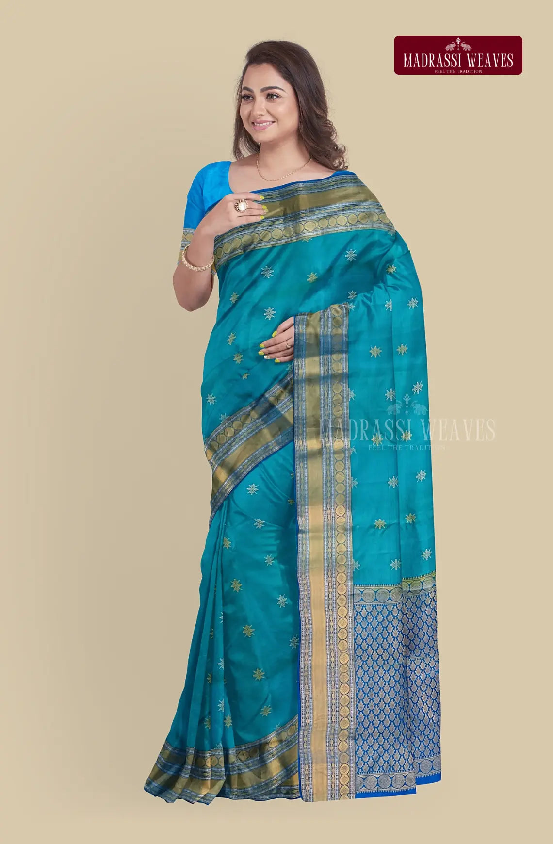This exquisite Kanjeevaram Pure Silk Saree in blue is woven with intricate meena butta work and zari detailing, making it the perfect wedding saree. Crafted from pure silk, it is silk mark certified for authenticity. The attached blouse material allows for a customizable fit. Elevate your style and buy now.