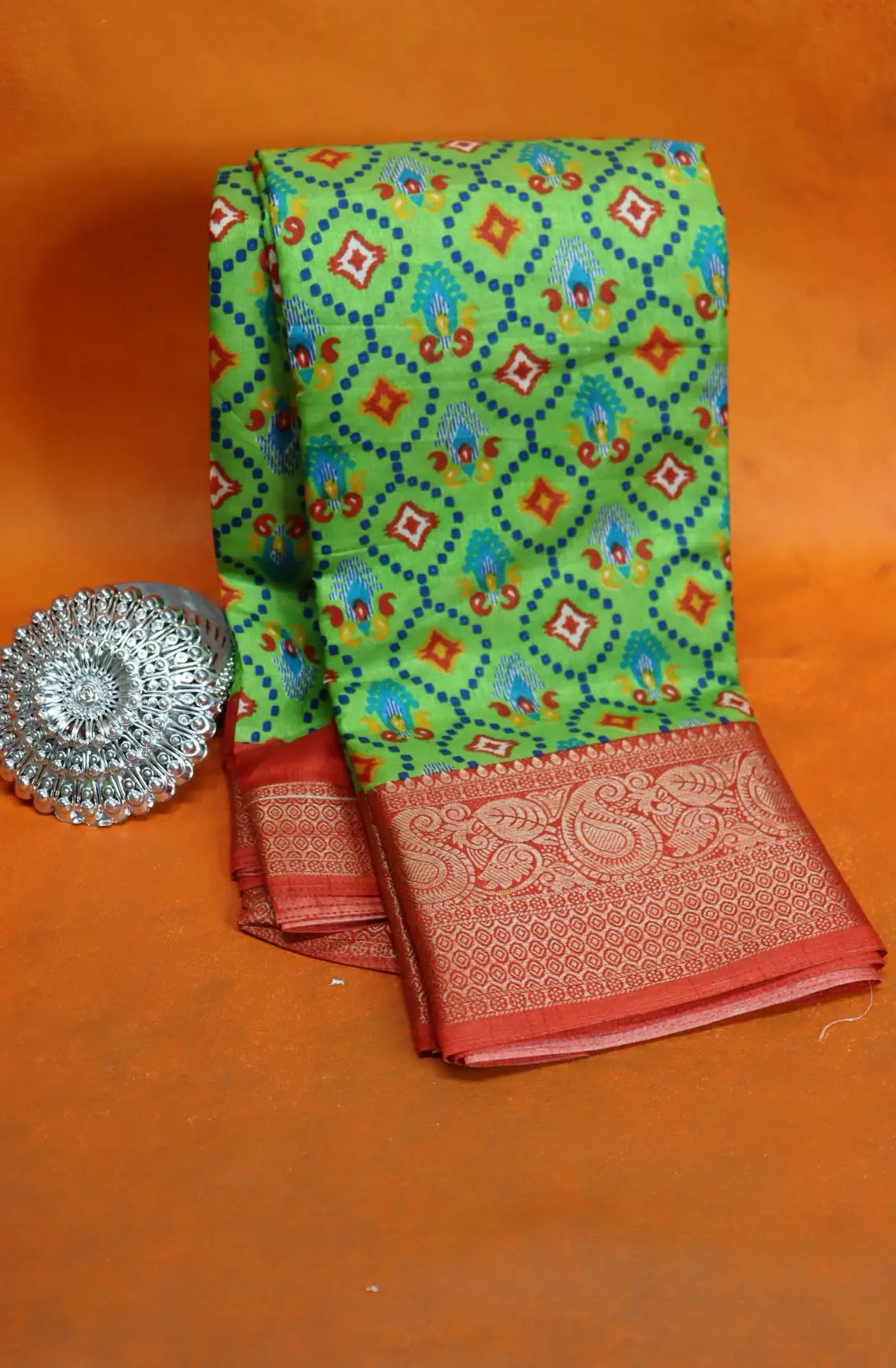 Elevate your style with our Patola Printed Saree! Made with fancy dola silk, it features a vibrant patola print and a stunning zari woven border. The rich mustard saree is accented with a maroon mango border, while the attached blouse material completes the ensemble. Available in six colours. Enjoy free shipping and an affordable price.