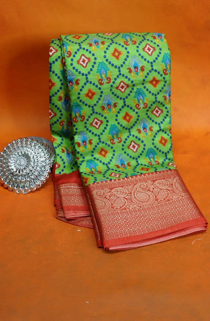 Elevate your style with our Patola Printed Saree! Made with fancy dola silk, it features a vibrant patola print and a stunning zari woven border. The rich mustard saree is accented with a maroon mango border, while the attached blouse material completes the ensemble. Available in six colours. Enjoy free shipping and an affordable price.