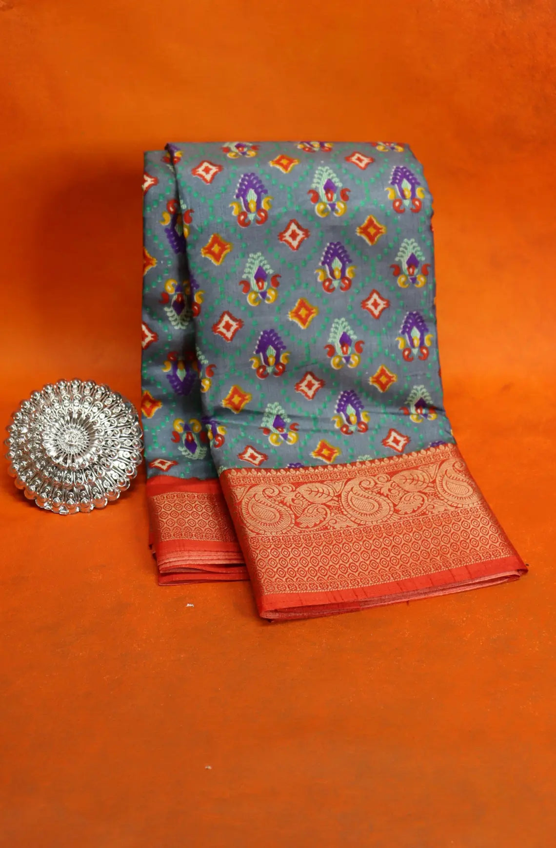 Elevate your style with our Patola Printed Saree! Made with fancy dola silk, it features a vibrant patola print and a stunning zari woven border. The rich mustard saree is accented with a maroon mango border, while the attached blouse material completes the ensemble. Available in six colours. Enjoy free shipping and an affordable price.
