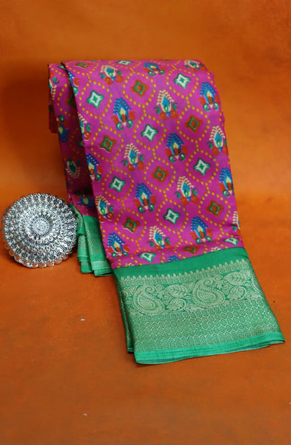Elevate your style with our Patola Printed Saree! Made with fancy dola silk, it features a vibrant patola print and a stunning zari woven border. The rich mustard saree is accented with a maroon mango border, while the attached blouse material completes the ensemble. Available in six colours. Enjoy free shipping and an affordable price.