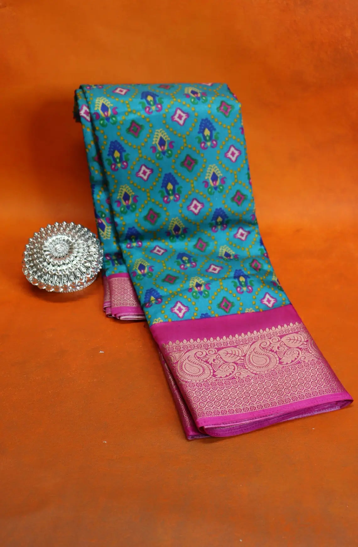 Elevate your style with our Patola Printed Saree! Made with fancy dola silk, it features a vibrant patola print and a stunning zari woven border. The rich mustard saree is accented with a maroon mango border, while the attached blouse material completes the ensemble. Available in six colours. Enjoy free shipping and an affordable price.
